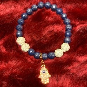 Navy blue beaded bracelet with hamsa hand hanging